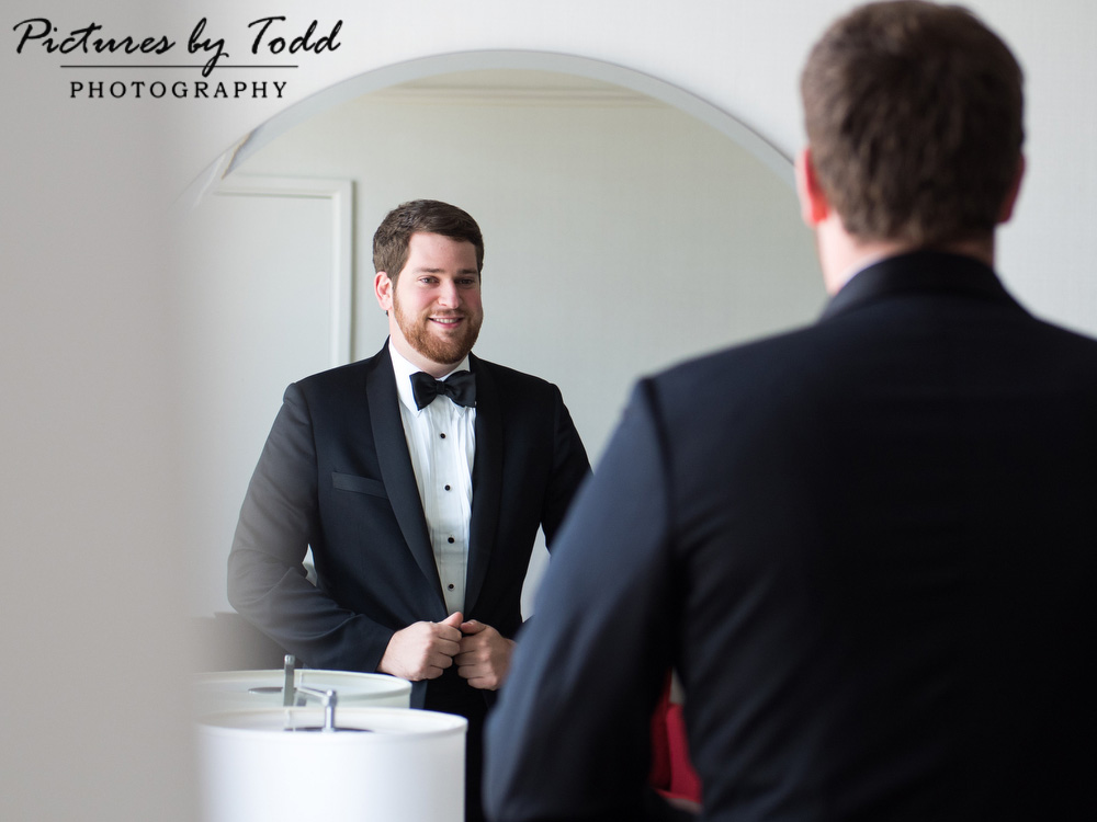 groom-getting-ready-mirror-happy-emotional-wedding-photography