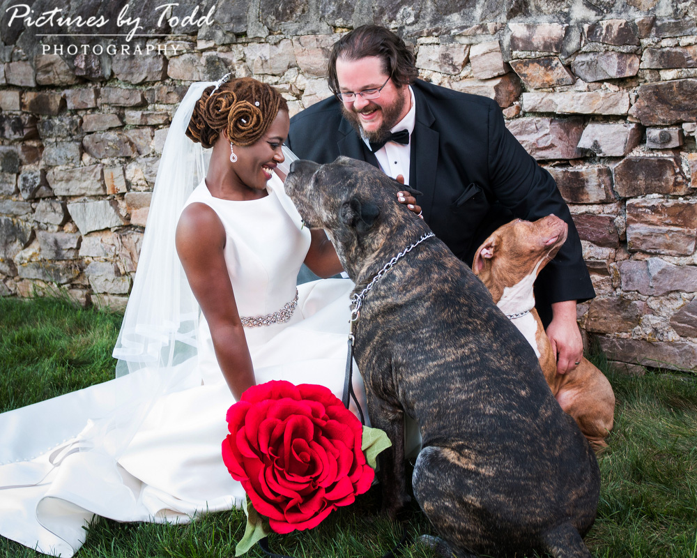 bride-and-groom-outdoor-dog-kiss-red-flower-unique-manor-house-philadelphia