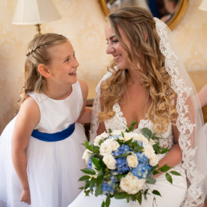 bride laughing with flower girls