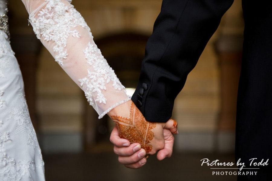bride and groom holding hands detail