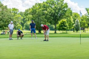 photo of men playing golf at golf outing