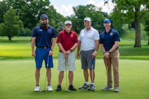 four golfers posing golf outing photo